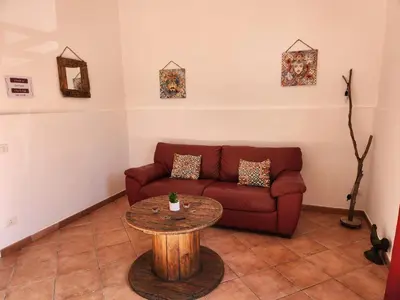 a living room with a couch and a table at Maison M&M in Palermo