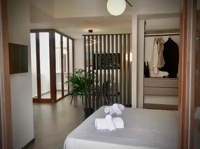 a room with a bed with towels on it at Ponticello Apartments in Palermo