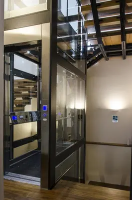 a glass elevator in a building with a staircase at Ponticello Apartments in Palermo