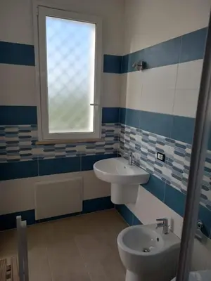 a bathroom with a sink and a toilet and a window at Tacco e Punta bed&breakfast in Grisi