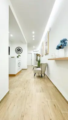 a living room with a chair and white walls at ARIA b&b in Terrasini