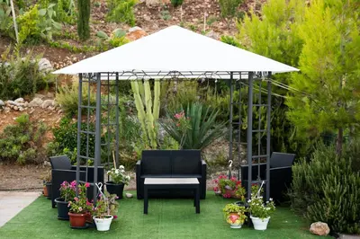 a white umbrella over a chair and some plants at Terrazza Sarmuci di Scopello in Scopello