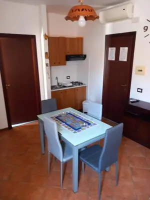 a kitchen and dining room with a table and chairs at A casa scalilla 2 in Palermo