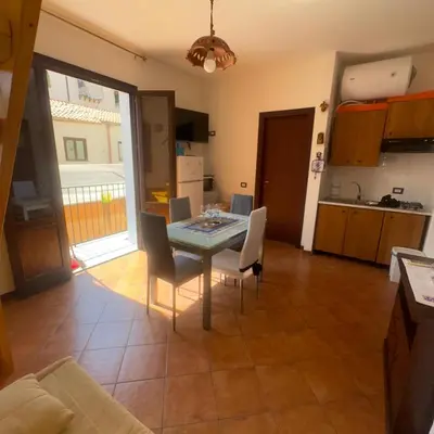 a kitchen and dining room with a table and chairs at A casa scalilla 2 in Palermo