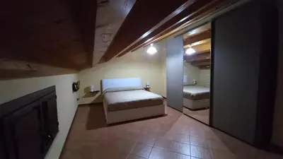 a small bedroom with a bed and a bathroom at A casa scalilla 2 in Palermo