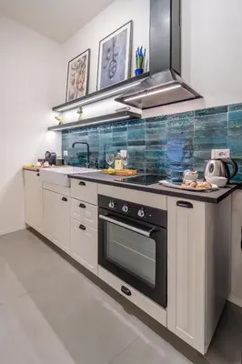 a kitchen with a stove and a sink at Trabia25 Suite Palermo in Palermo