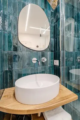 a bathroom with a white sink and a mirror at Trabia25 Suite Palermo in Palermo