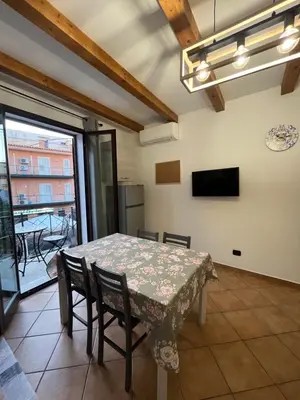 a dining room with a table and chairs at MAESTRALE CASA VACANZA in Isola delle Femmine