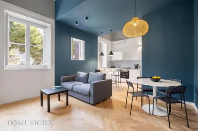 a living room with a couch and a table at Real Tenuta Apartments By Domus Sicily in Palermo