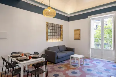 a living room with a couch and a table at Real Tenuta Apartments By Domus Sicily in Palermo