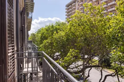 a balcony of a building with trees and buildings at Real Tenuta Apartments By Domus Sicily in Palermo