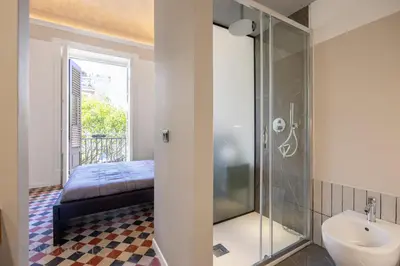 a bathroom with a bed and a shower and a sink at Real Tenuta Apartments By Domus Sicily in Palermo
