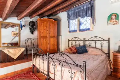 a bedroom with a metal bed in a room at casa Ennio by Villa Paola Ciminna in Ciminna