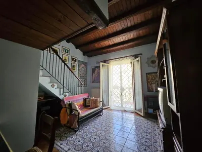 a living room with a staircase and a stair case at casa Ennio by Villa Paola Ciminna in Ciminna