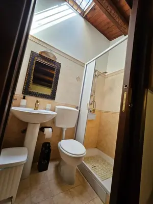 a bathroom with a toilet and a sink and a shower at casa Ennio by Villa Paola Ciminna in Ciminna