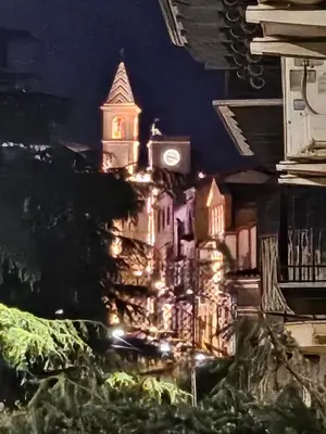 a building with a clock tower at night at casa Ennio by Villa Paola Ciminna in Ciminna