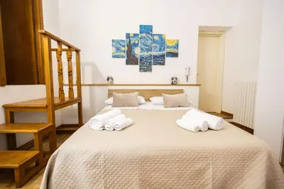 a bedroom with a bed with towels on it at Noble Suite in Palermo