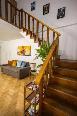 a living room with a staircase and a couch at Noble Suite in Palermo