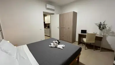 a white teddy bear sitting on a bed in a bedroom at Cuba Holiday House in Palermo