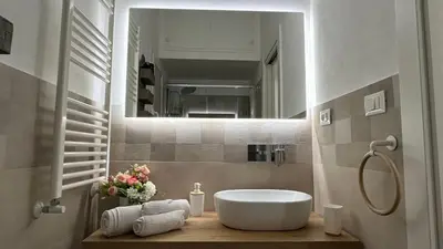 a bathroom with a white tub and a mirror at Cuba Holiday House in Palermo