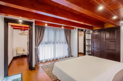 a bedroom with a bed and a large window at Behind the Cathedral apt in Palermo