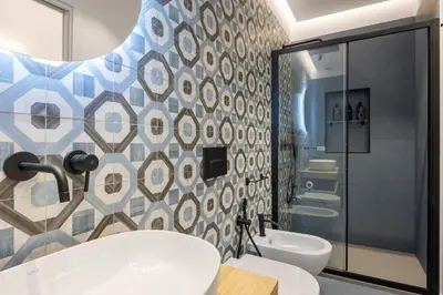 a bathroom with a tub and a toilet and a sink at Roccella Apartments in Palermo