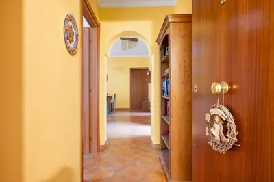 a hallway of a house with a book shelf at Camera con bagno cucina e terrazza al Vicoletto al Massimo in Palermo