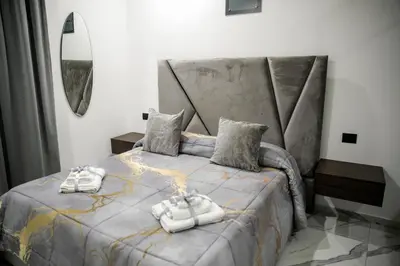 a bedroom with a bed with two towels on it at Suite del Principe - Prince's Suite. in Palermo