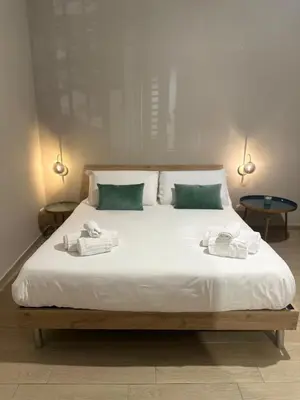 a bedroom with a large bed with towels on it at Villafranca settantuno Apartments in Palermo