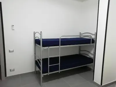 a room with two bunk beds in a room at Casa Nino' in Palermo