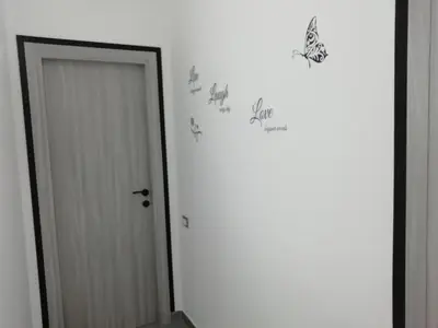 a hallway with a door with animals stenciled on the wall at Casa Nino' in Palermo