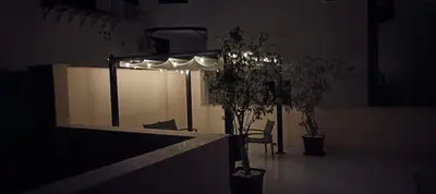 a light in a dark room with a table and plants at Casa Nino' in Palermo
