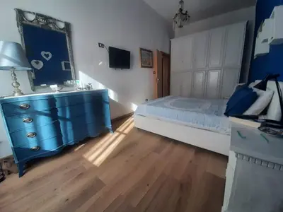 a bedroom with a blue dresser and a blue mirror at Casa Ore-Tea in Palermo