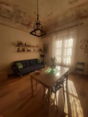 a living room with a table and a couch at Casa Ore-Tea in Palermo
