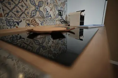 a counter in a bathroom with a laptop on it at Kanat Apartment in Palermo
