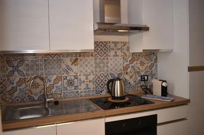 a kitchen with a sink and a counter top at Kanat Apartment in Palermo