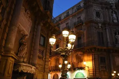 a street light in front of a large building at Kanat Apartment in Palermo