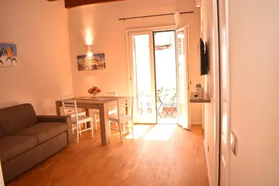 a living room with a table and a couch at Kanat Apartment in Palermo