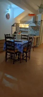 a kitchen with a table with a laptop on it at alloggio in Palermo