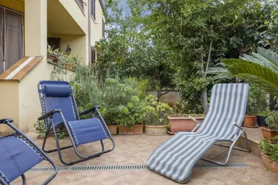 a pair of chairs sitting on a patio at alloggio in Palermo