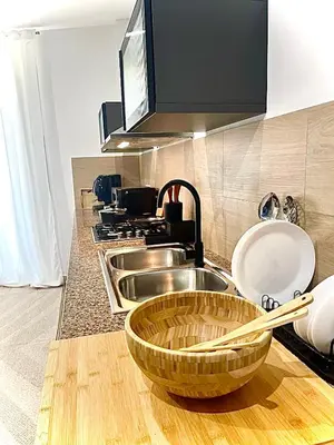 a kitchen with a row of sinks on a counter at La Riva - Seashore in Bagheria