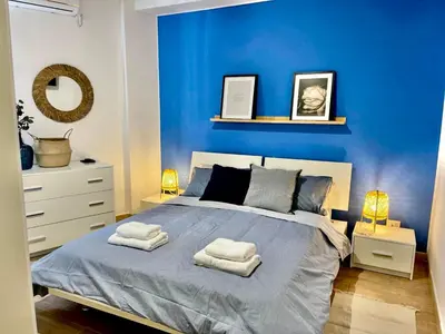 a blue bedroom with a bed with two towels on it at La Riva - Seashore in Bagheria