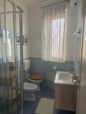 a bathroom with a toilet and a sink at La Riva - Seashore in Bagheria
