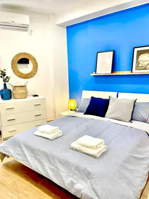 a blue bedroom with a bed with towels on it at La Riva - Seashore in Bagheria