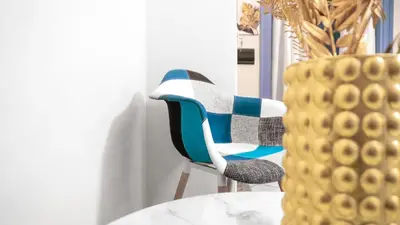 a chair sitting next to a table and a vase at VICTORIO APARTMENT in Palermo
