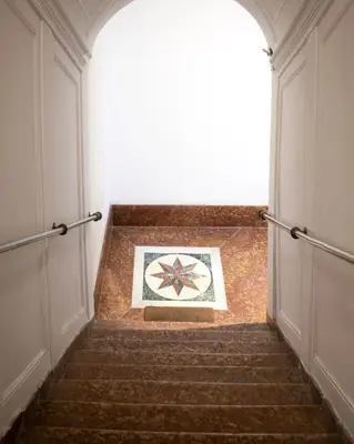 a stairway leading up to a building with a clock at VICTORIO APARTMENT in Palermo