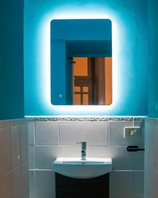 a bathroom with a sink and a blue mirror at VICTORIO APARTMENT in Palermo