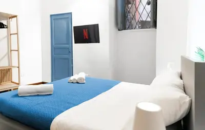 a bedroom with a large bed with towels on it at VICTORIO APARTMENT in Palermo