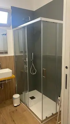 a shower with a glass door in a bathroom at Mondello Twentytwo House in Palermo