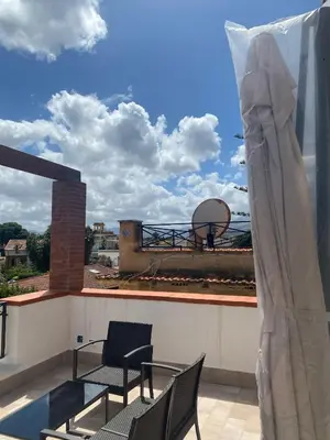 a balcony with chairs and a basketball hoop on a roof at Mondello Twentytwo House in Palermo